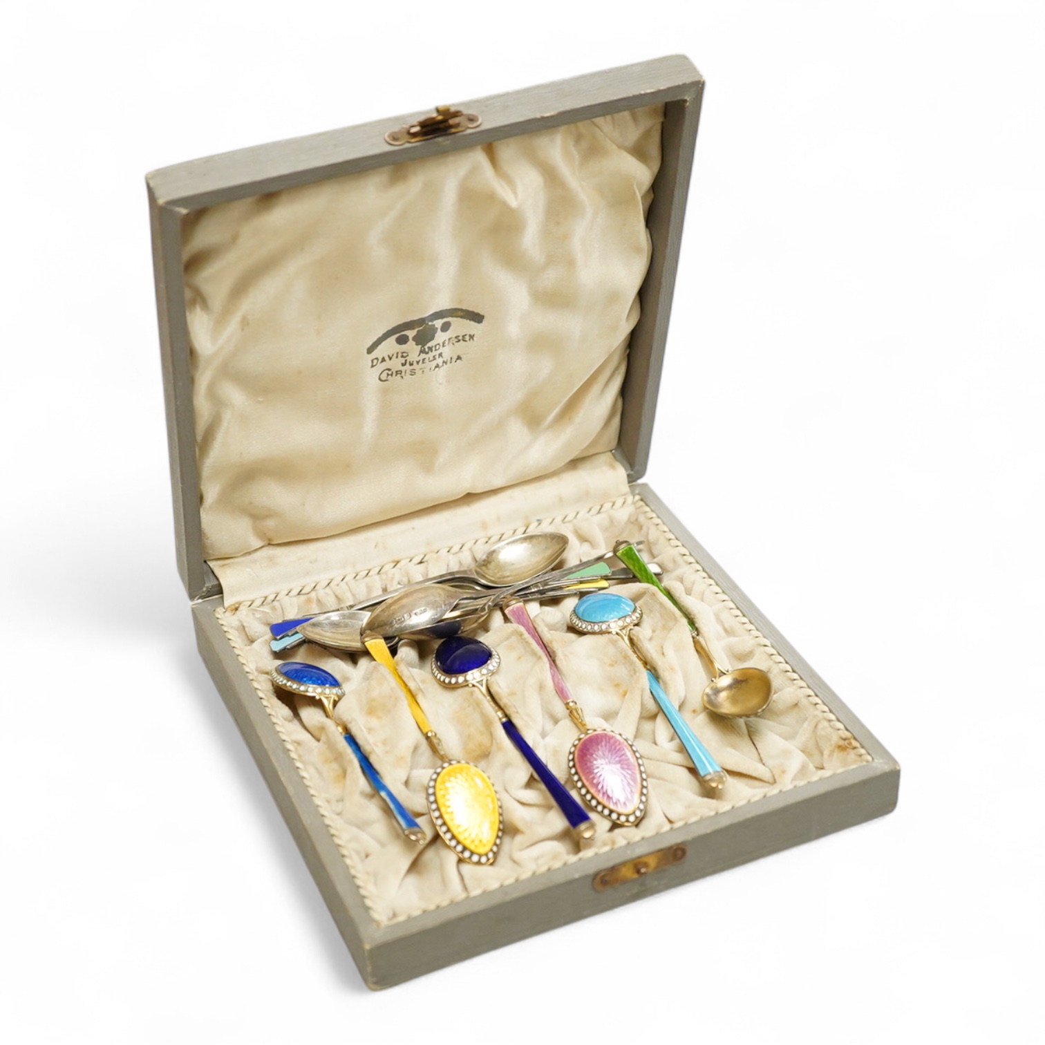 A cased set of silver Norwegian gilt 925 and polychrome enamelled coffee spoons(a.f.), 93mm, together with a set of six George V silver coffee spoons, with enamelled terminals, Deakin & Francis, Birmingham, 1933.